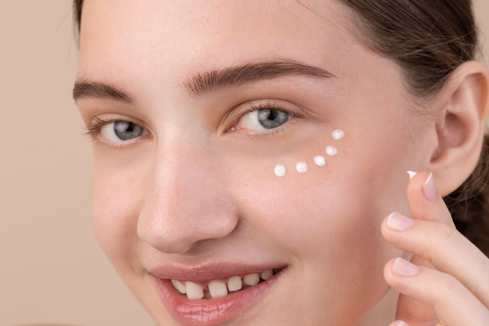 Close up smiley model using eye cream.