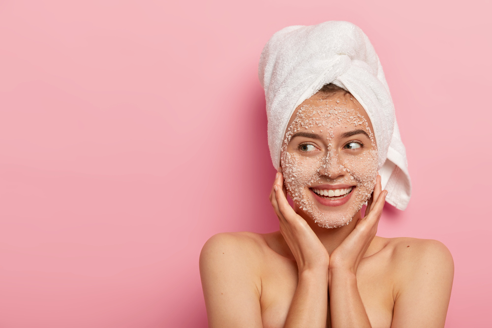 A young woman is following her skin exfoliator technique.