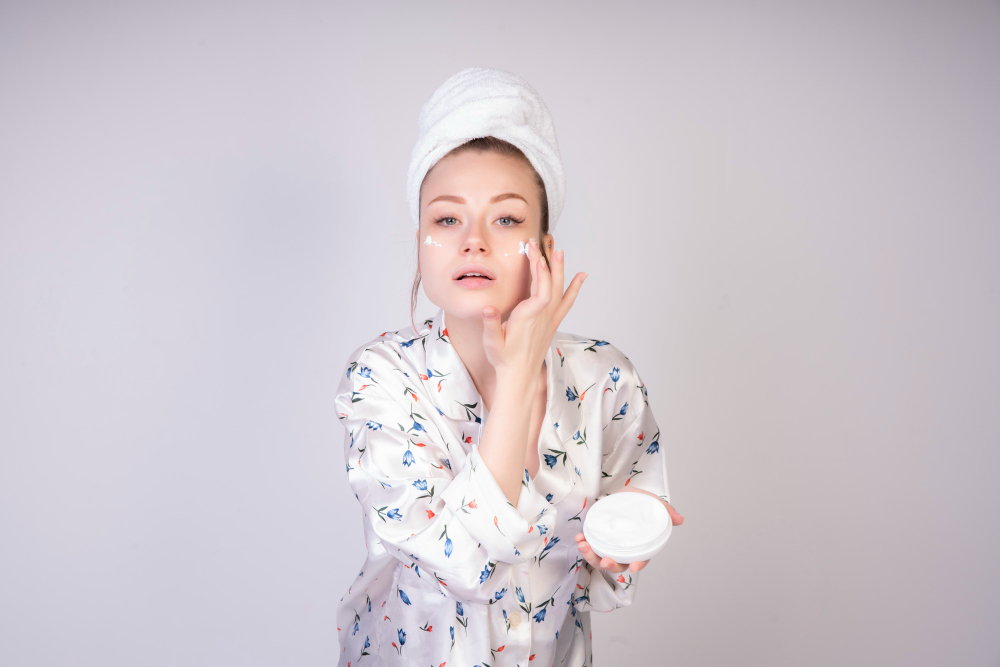 Motivated girl applying acne cream.