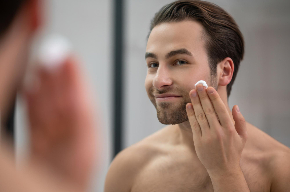 Young Man applying makeup and Skincare products.