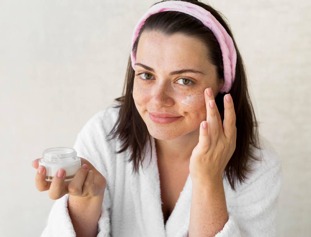 Medium shot woman using kojic acid face cream.