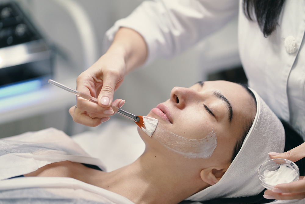 Young women applying Lactic acid peel solution.